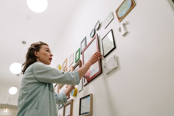 woman arranging frames